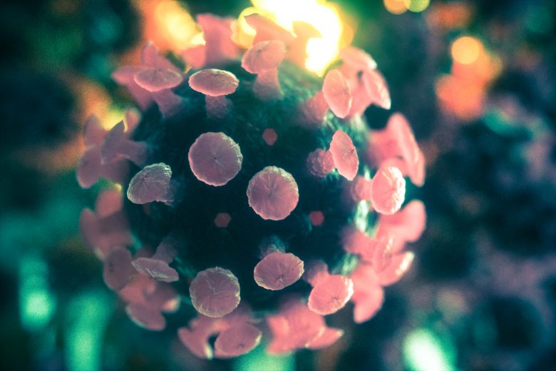 3D Abbildung des Coronavirus in Grün- und Rosétönen.