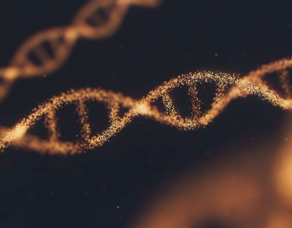 Bild zweier abstrahierter DNA-Stränge in Gold vor schwarzem Hintergrund.